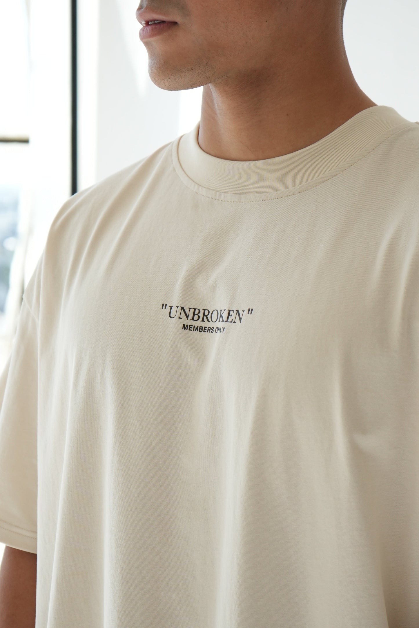 "UNBROKEN" OVERSIZED UNISEX TEE - LIGHT CREAM from NXTLVL ATHLETIC